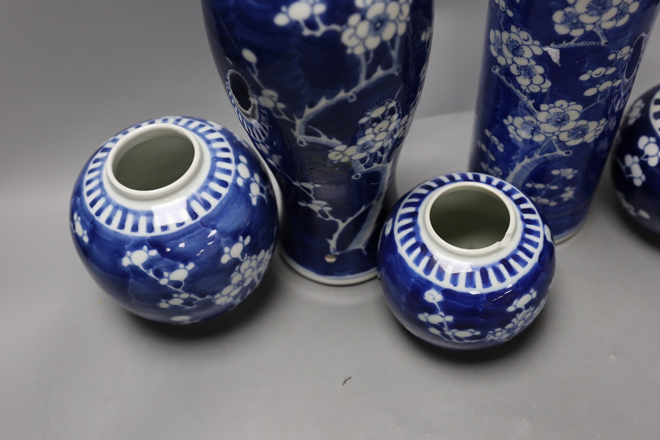 Two 19th / 20th century Chinese blue and white prunus vases and three jars, tallest 29cm